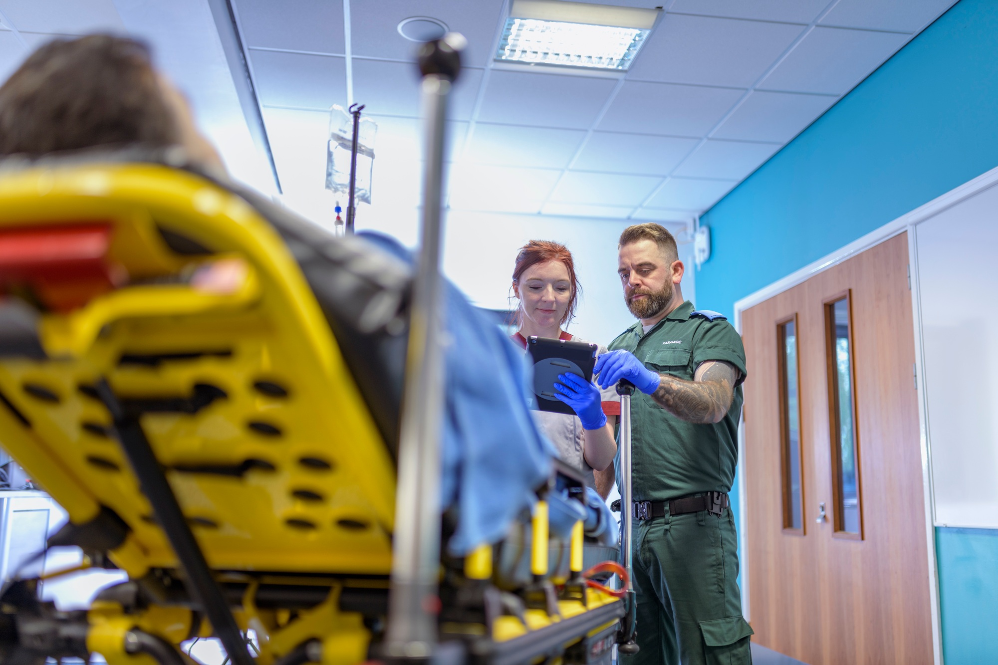 Emergency paramedics handing over patient to emergency nurse